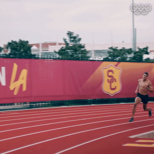 Shirtless Man Running On Track GIF