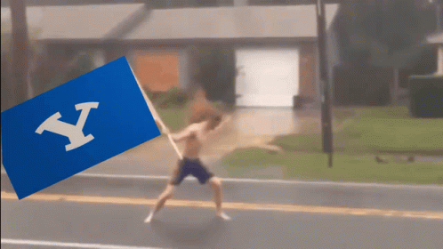 Shirtless Man Running With Blue Flag Letter Y