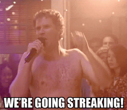 Shirtless Man Singing We're Going Streaking into Microphone