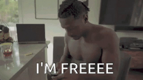Shirtless Man Sits Laptop Says I'm Freeee on Phone