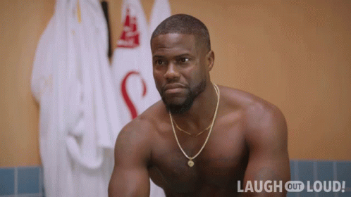 Shirtless Man Sitting by Laugh Out Loud Sign