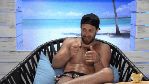 Shirtless Man Sitting In Wicker Chair With Beach Scene GIF