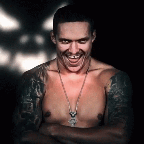 Shirtless Man Smiling With Cross Necklace