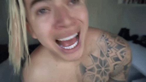 Shirtless Man Smiling with Tattoo