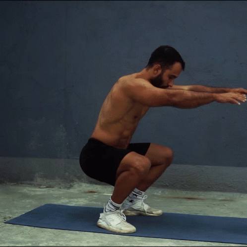 Shirtless Man Squatting On Yoga Mat GIF