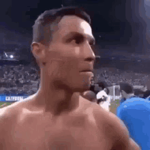 Shirtless Man Standing Before Crowd