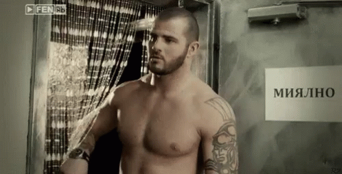 Shirtless Man Standing By Mialno Sign GIF
