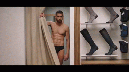 Shirtless Man Standing in Dressing Room
