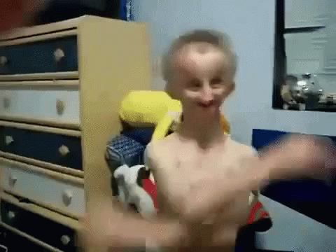 Shirtless Man Standing in Front of Dresser