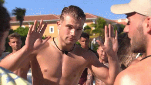 Shirtless Man Standing in Front of Group