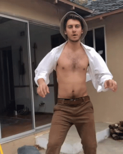 Shirtless Man Standing In Front Of House GIF
