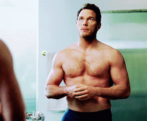 Shirtless Man Standing in Front of Mirror