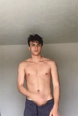 Shirtless Man Standing in Front of Wall
