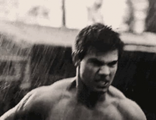 Shirtless Man Standing In Rain GIF