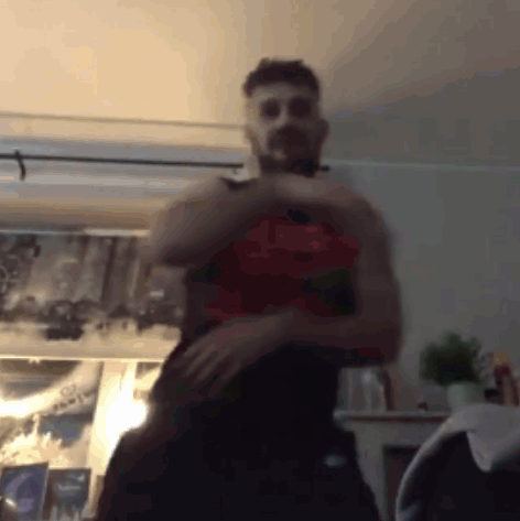 Shirtless Man Standing in Room with Picture