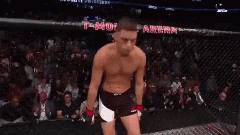 Shirtless Man Standing in UFC Cage