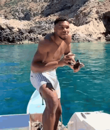 Shirtless Man Standing on Boat