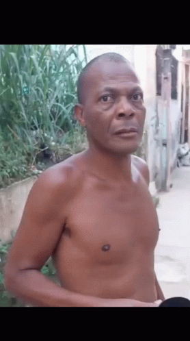Shirtless Man Standing On Sidewalk GIF