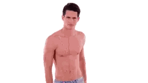 Shirtless Man Standing with Hands in Pockets