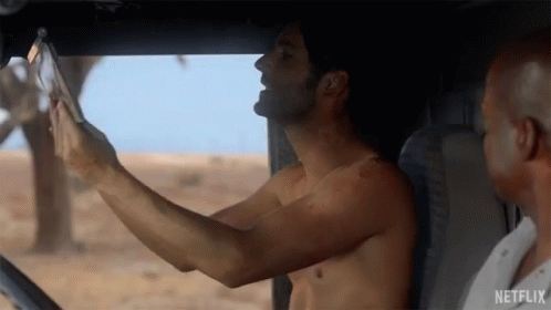 Shirtless Man Taking Selfie in Car