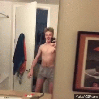 Shirtless Man Taking Selfie in Mirror