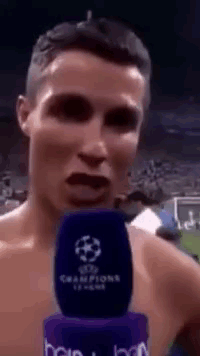Shirtless Man Talking Into Champions League Microphone