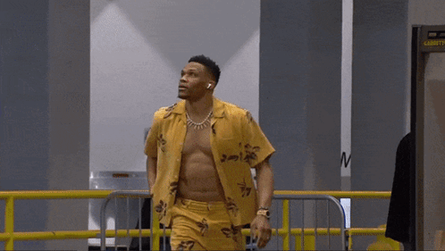 Shirtless Man Walking Through Security Checkpoint GIF
