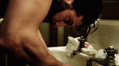 Shirtless Man Washing Face