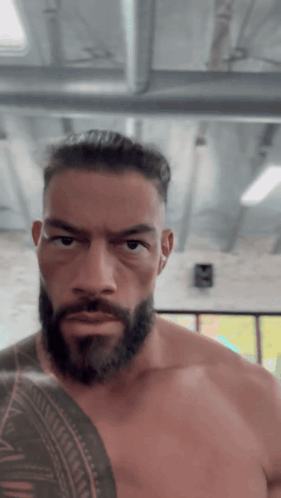 Shirtless Man With Beard And Arm Tattoo GIF