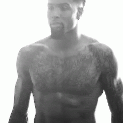 Shirtless Man with Beard and Chest Tattoos