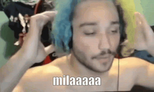 Shirtless Man With Blue Hair and Headphones Making Funny Face