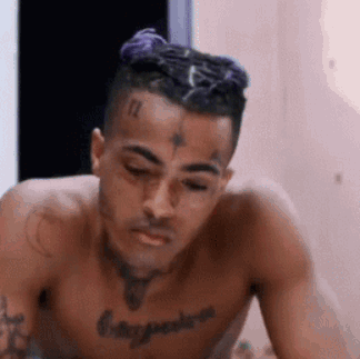 Shirtless Man With Chest Tattoo Sitting Eyes Closed