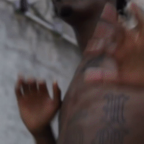 Shirtless Man With Chest Tattoo Waving