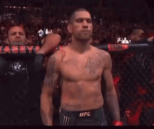 Shirtless Man With Dragon Tattoo Standing Before Crowd