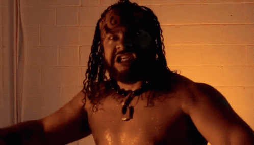Shirtless Man with Dreadlocks and J Necklace