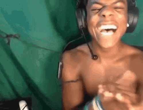 Shirtless Man With Headphones and Microphone Laughing