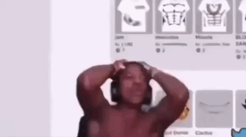 Shirtless Man With Headphones Standing in Front of Wall With Shirts