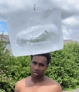 Shirtless Man with Ice Cube on Head