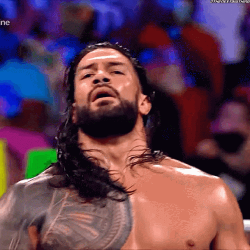 Shirtless Man with Long Hair and Beard in Crowd