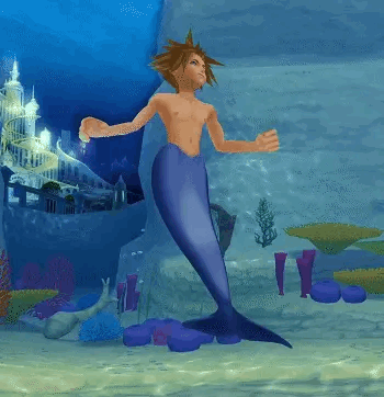 Shirtless Man With Mermaid Tail Standing In Water GIF