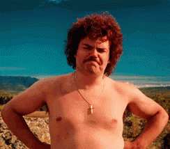 Shirtless Man With Mustache and Cross Necklace Hands on Hips