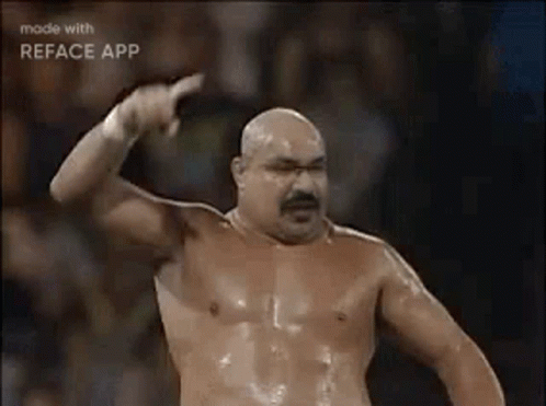Shirtless Man with Mustache Pointing at Camera