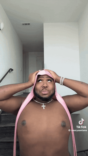 Shirtless Man With Pink Scarf and Cross Necklace