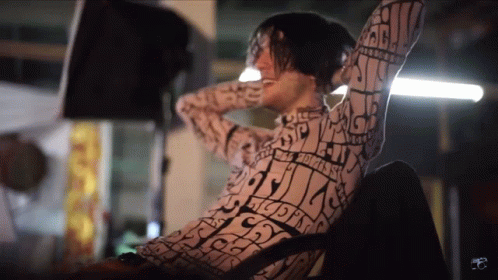 Shirtless Man With Rainbow Cape Says Happy Friday GIF