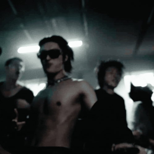 Shirtless Man with Sunglasses and Choker in Crowd