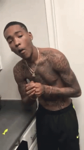 Shirtless Man With Tattoos On Kitchen Counter GIF