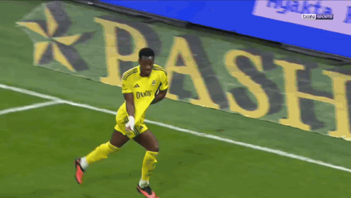 Shirtless Soccer Player Running in Front of Beko Banner