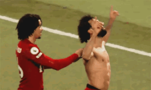 Shirtless Soccer Player Standing Next to Another