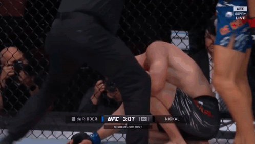 Shirtless UFC Fighter in Front of Cage