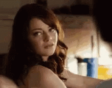 Shirtless Woman Sitting on Bed Looking at Man